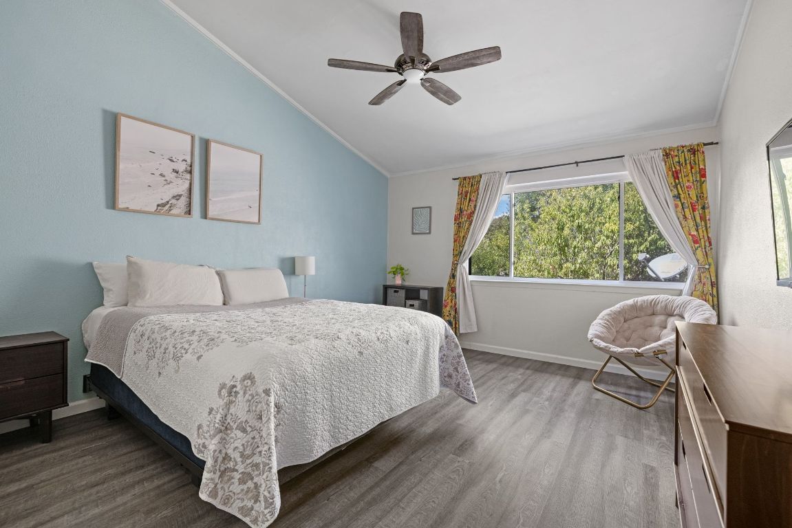 8906 Trone Circle, Unit A Austin, TX 78758 - Photo 20 of 33 a bedroom with a bed a chair and a large window