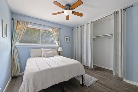 a bedroom with a bed and a large window