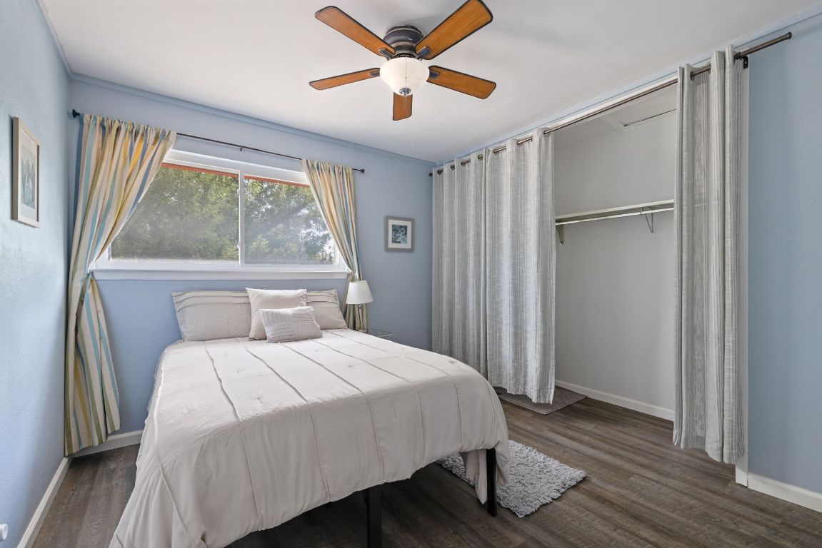 8906 Trone Circle, Unit A Austin, TX 78758 - Photo 26 of 33 a bedroom with a bed and a large window