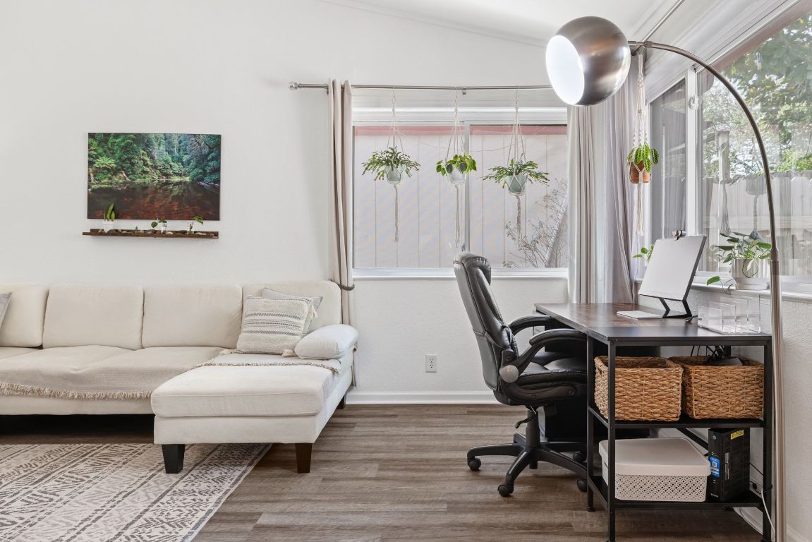 8906 Trone Circle, Unit A Austin, TX 78758 - Photo 8 of 33 a living room with furniture a large window and a chandelier