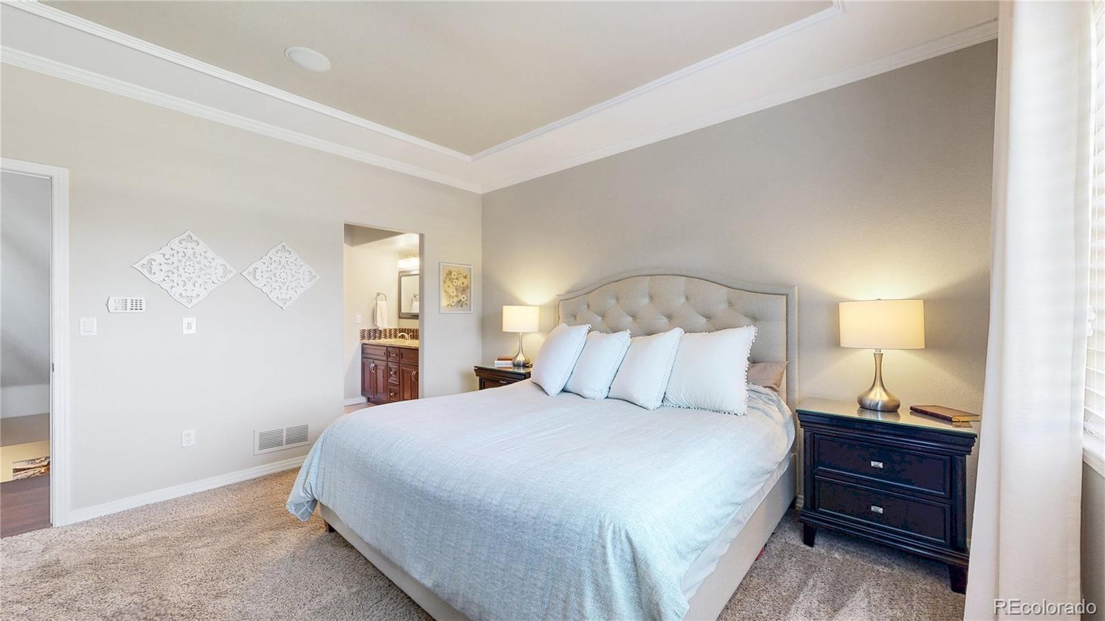 3401 West 111th Loop, Unit B Westminster, CO 80031 - Photo 11 of 40 a bedroom with a bed and a night stand