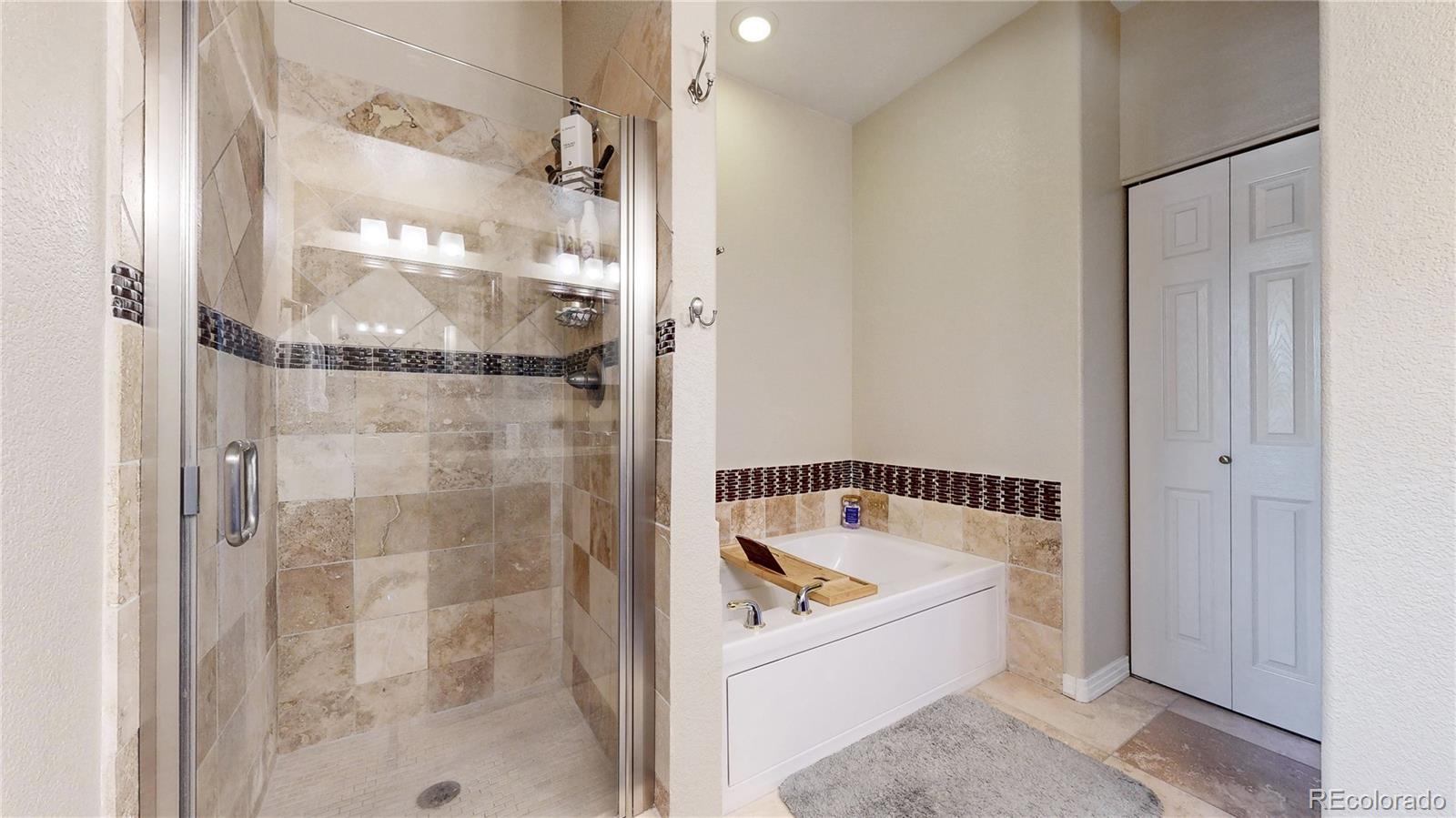 3401 West 111th Loop, Unit B Westminster, CO 80031 - Photo 13 of 40 a bathroom with a bathtub and a shower