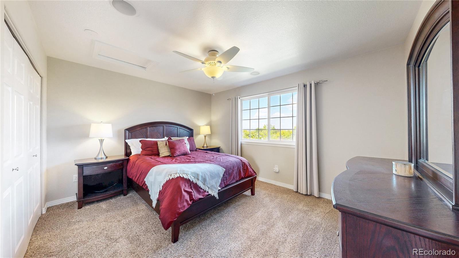 3401 West 111th Loop, Unit B Westminster, CO 80031 - Photo 18 of 40 a bedroom with a bed and window