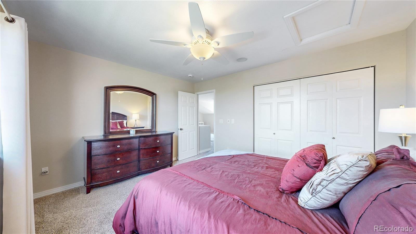 3401 West 111th Loop, Unit B Westminster, CO 80031 - Photo 19 of 40 a bedroom with a bed and a dresser