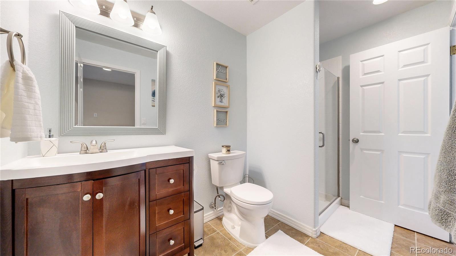 3401 West 111th Loop, Unit B Westminster, CO 80031 - Photo 20 of 40 a bathroom with a toilet sink and mirror