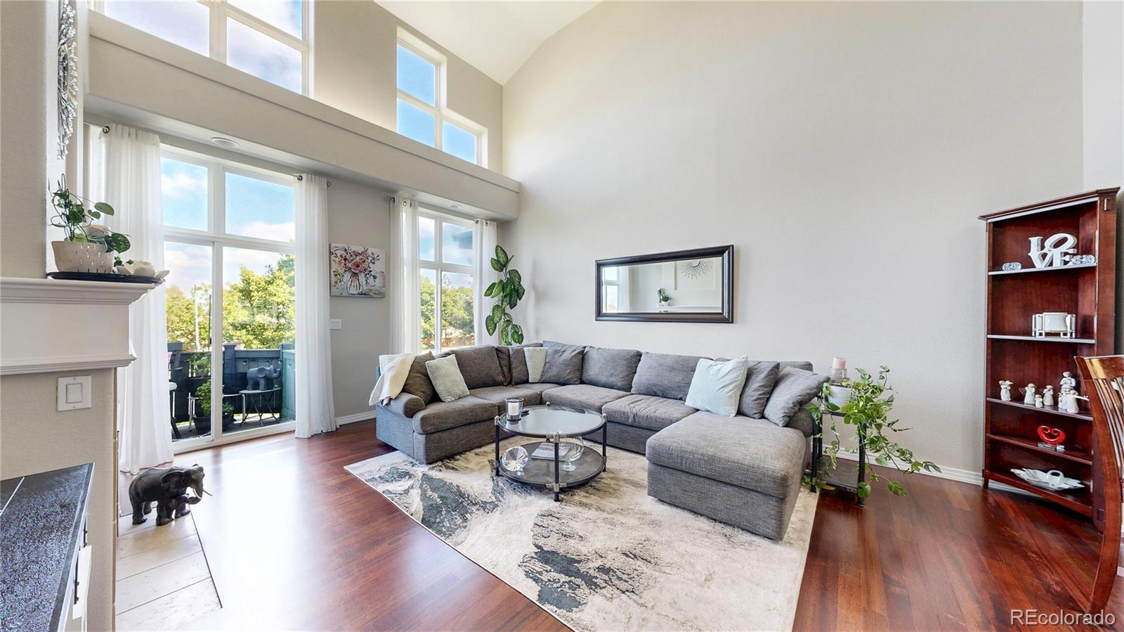 3401 West 111th Loop, Unit B Westminster, CO 80031 - Photo 2 of 40 a living room with furniture and a book shelf