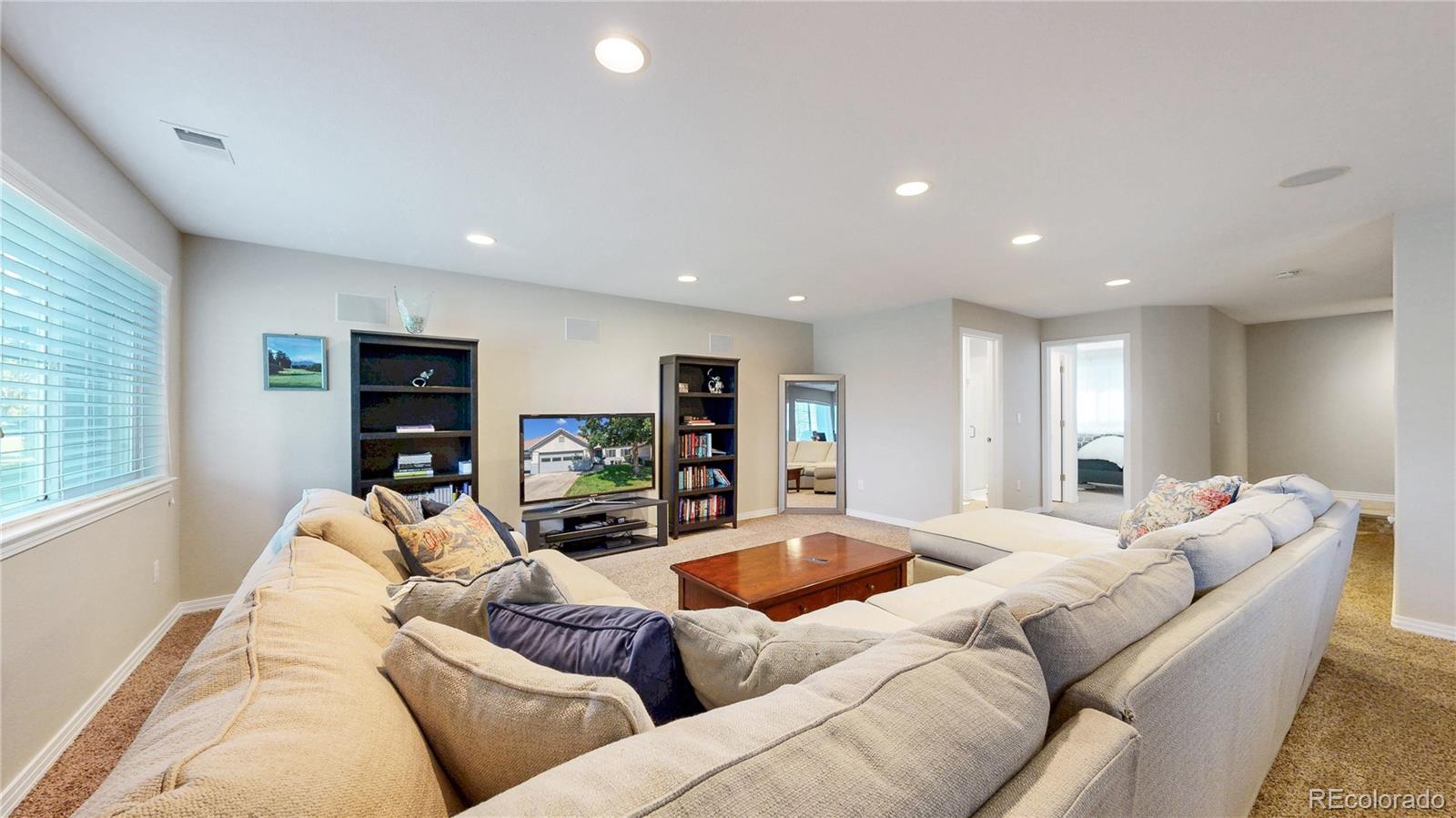 3401 West 111th Loop, Unit B Westminster, CO 80031 - Photo 21 of 40 a living room with furniture and a flat screen tv