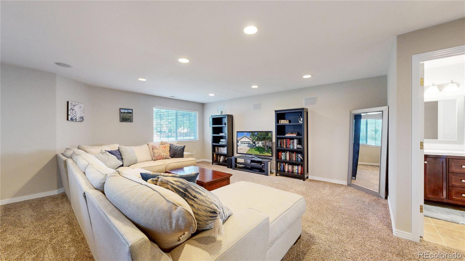 3401 West 111th Loop, Unit B Westminster, CO 80031 - Photo 22 of 40 a living room with furniture and a flat screen tv