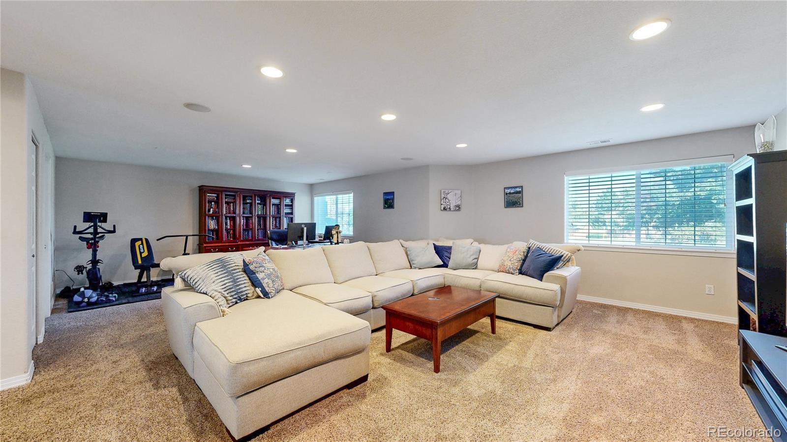 3401 West 111th Loop, Unit B Westminster, CO 80031 - Photo 23 of 40 a living room with furniture and a window