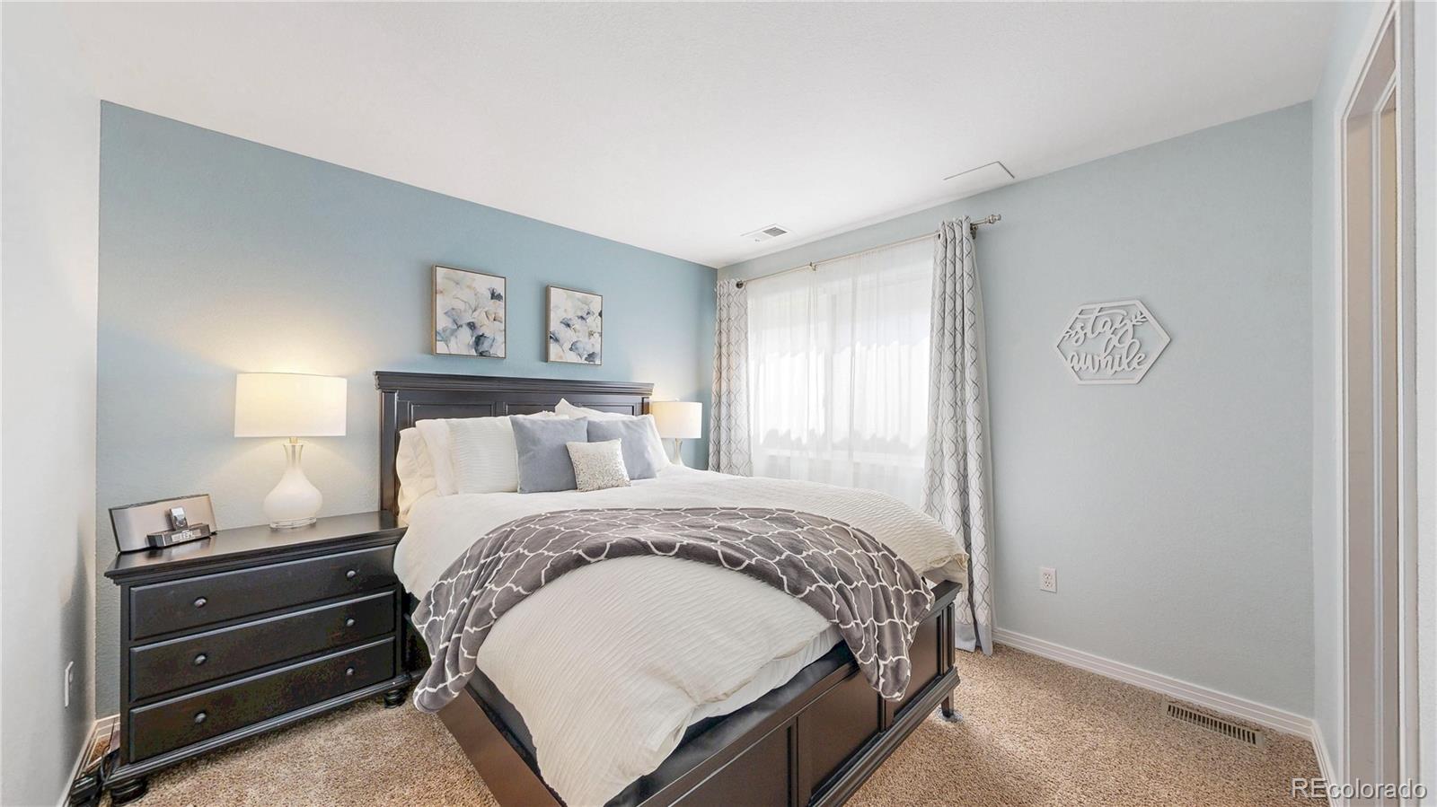 3401 West 111th Loop, Unit B Westminster, CO 80031 - Photo 25 of 40 a bed room with a bed and a window