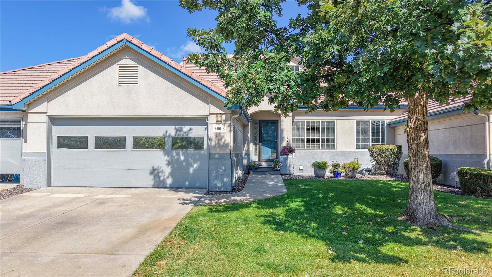 3401 West 111th Loop, Unit B Westminster, CO 80031 - Photo 39 of 40 a front view of a house with a yard and trees