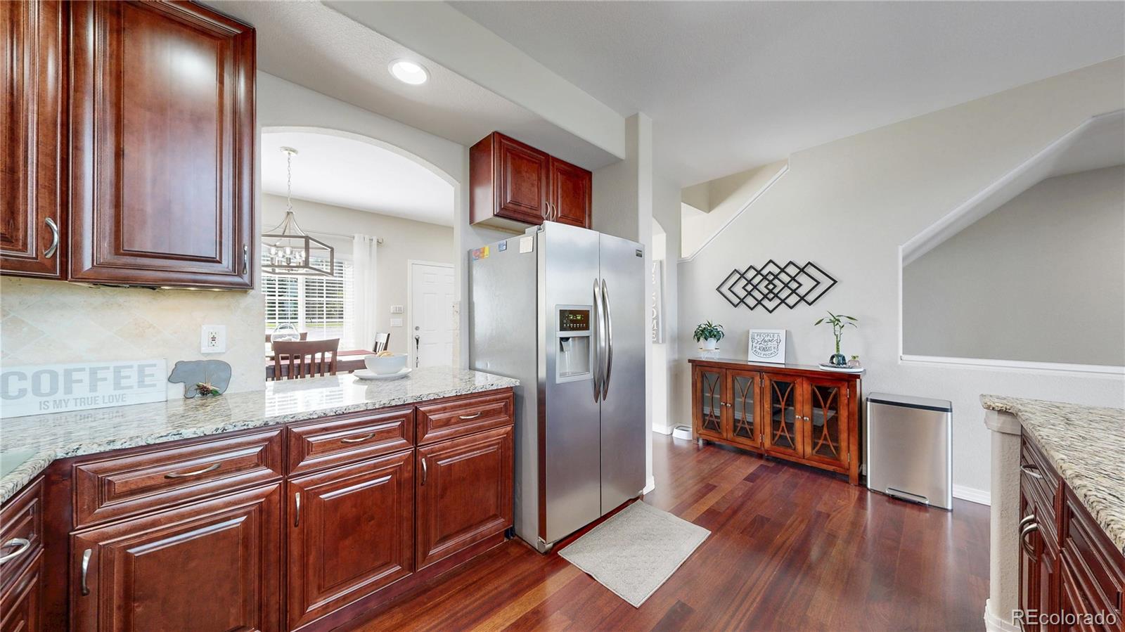 3401 West 111th Loop, Unit B Westminster, CO 80031 - Photo 7 of 40 a kitchen with stainless steel appliances granite countertop a refrigerator a stove and a wooden floors