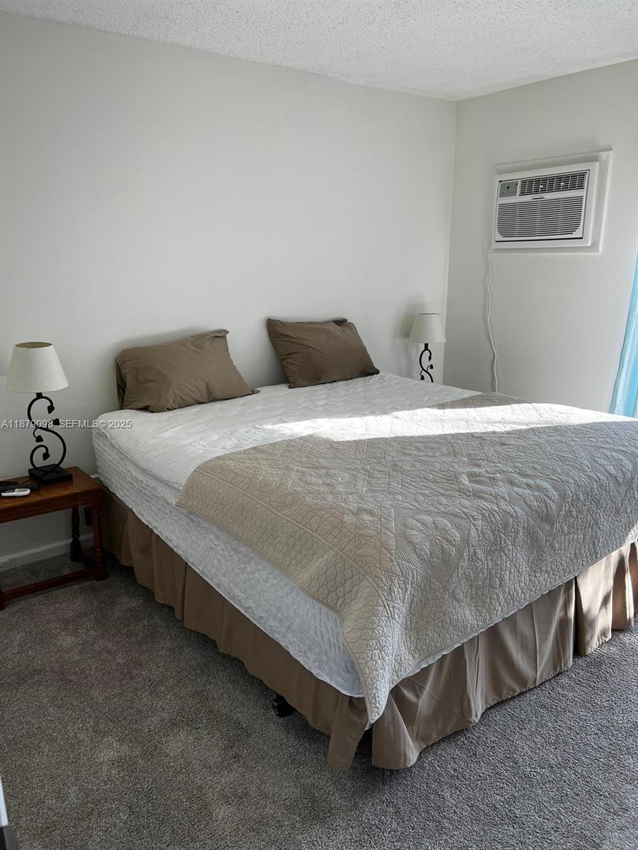 22 Brighton A, Unit 22 Boca Raton, FL 33434 - Photo 11 of 12 a bedroom with a bed and a lamp with the dresser