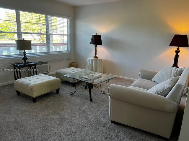 a living room with furniture and a lamp
