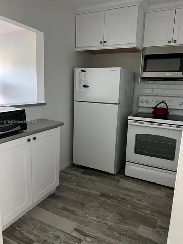 a kitchen with cabinets and steel stainless steel appliances