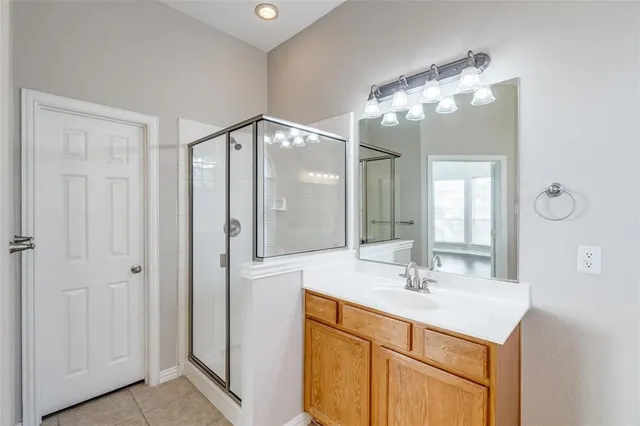a bathroom with a sink vanity and a mirror