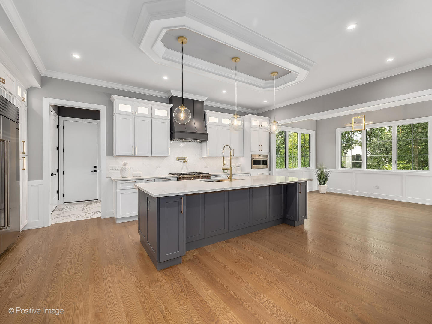 11480 Circle Drive Burr Ridge, IL 60527 - Photo 8 of 53 a large kitchen with stainless steel appliances a large counter top a stove a sink dishwasher a refrigerator and a dining table with wooden floor
