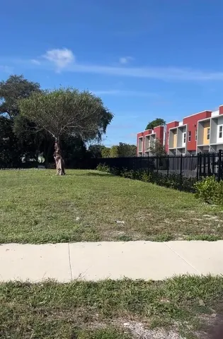 a view of a yard with a house in the background