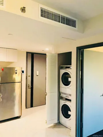 a view of a kitchen with a refrigerator washer and dryer