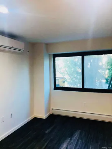 a view of room with wooden floor and window