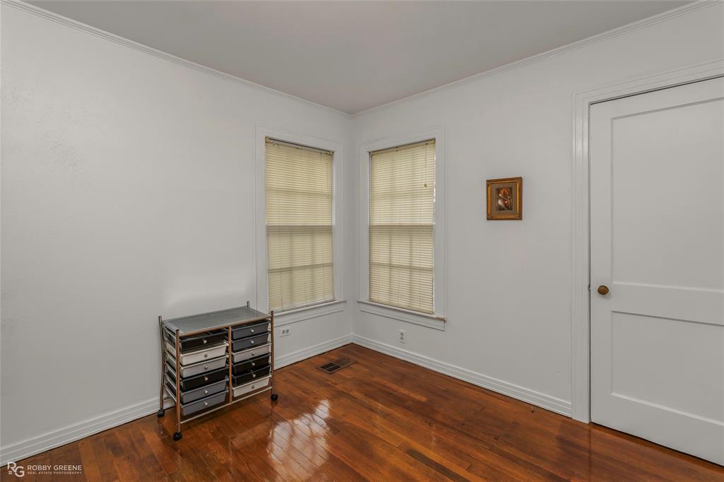 515 Davis Street Minden, LA 71055 - Photo 13 of 28 an empty room with wooden floor and windows