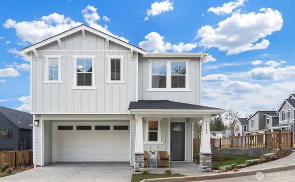a living room with fireplace furniture and a large window