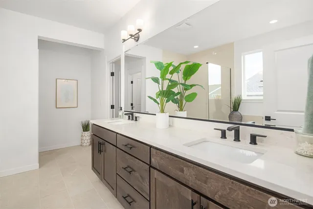 a bathroom with a double vanity sink and a mirror