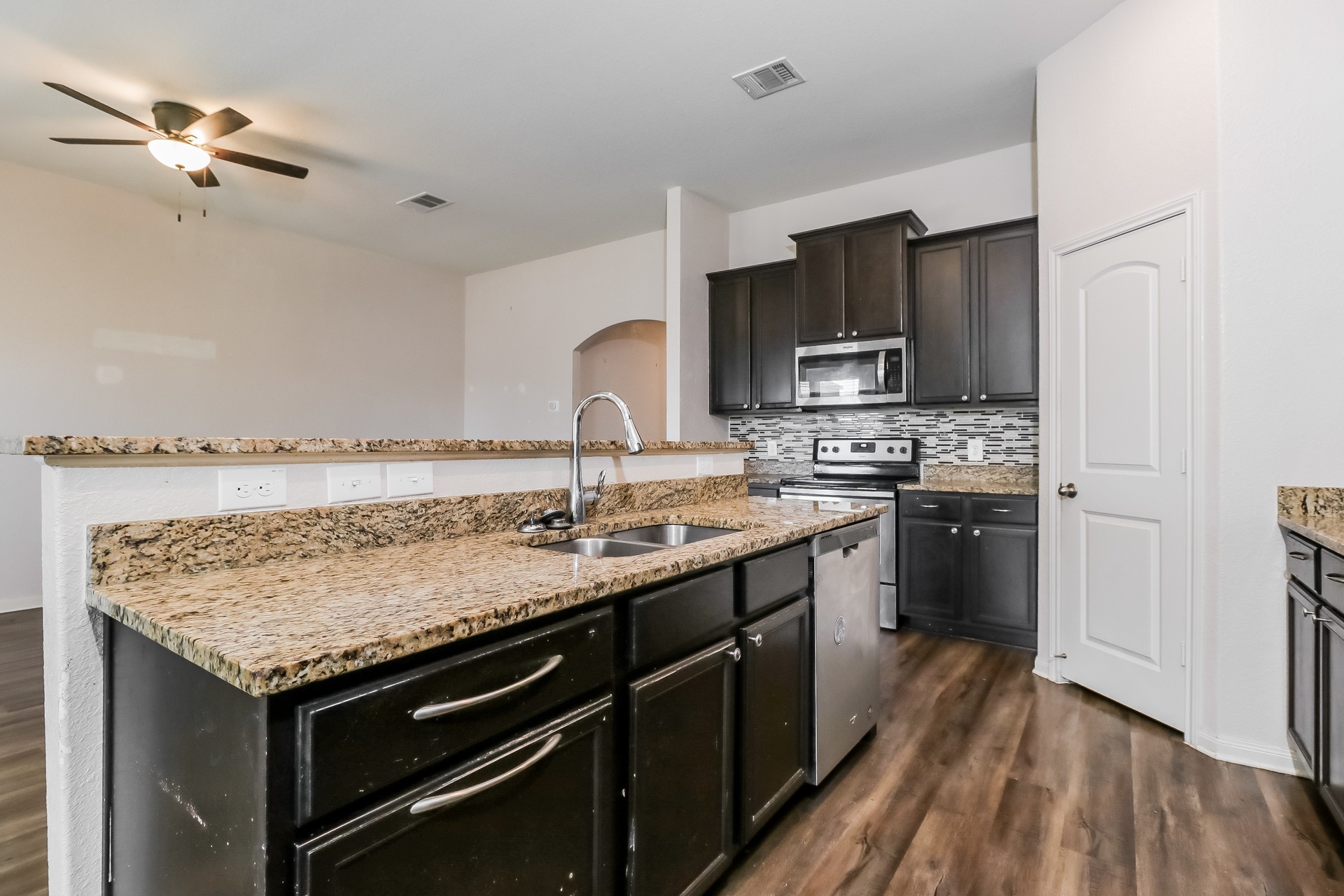 20017 Hubert R Humphrey Road Manor, TX 78653 - Photo 6 of 27 A functional kitchen boasts granite countertops and stainless steel appliances, perfect for everyday meals.