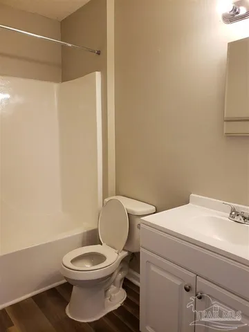 a white toilet sitting next to a bathroom sink