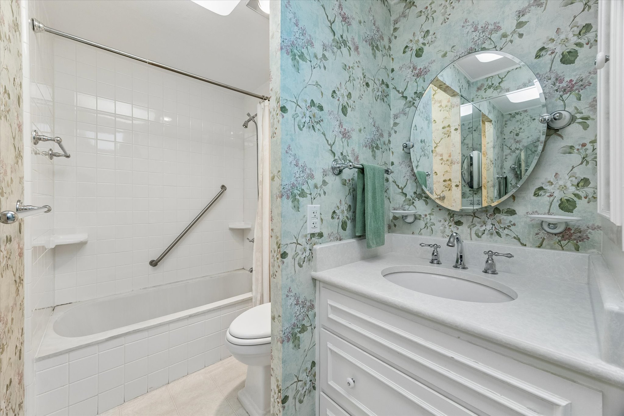 1801 Lavaca Street, Unit 6E Austin, TX 78701 - Photo 16 of 32 2nd Bathroom featuring vanity, wallpapered walls, and light tile patterned floors