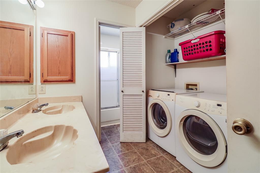 1728 Hackamore Street Mesquite, TX 75149 - Photo 15 of 22 Secondary bathroom with double sinks and washer and dryer area.