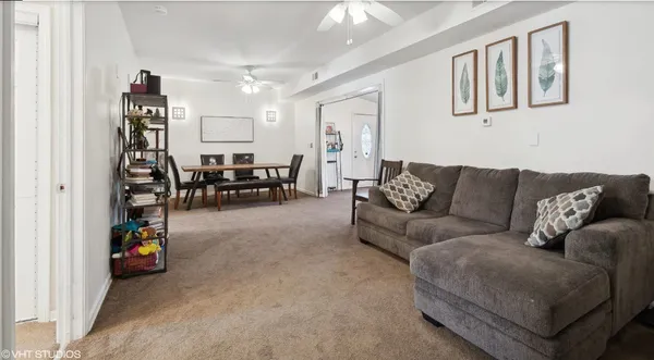 a living room with furniture and a dining table