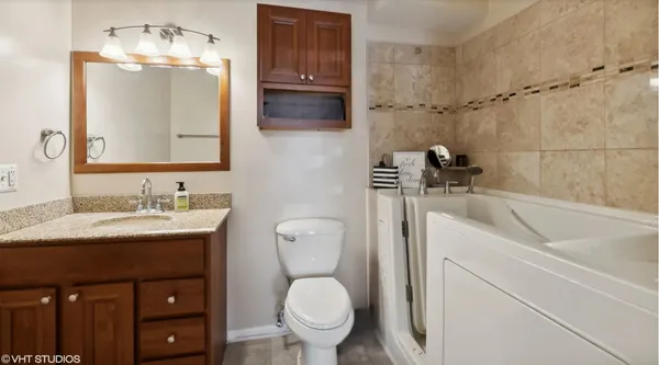 a bathroom with a toilet sink and mirror