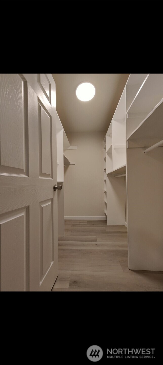2411 South 248th Street, Unit D24 Kent, WA 98032 - Photo 17 of 21 a view of entryway with wooden floor