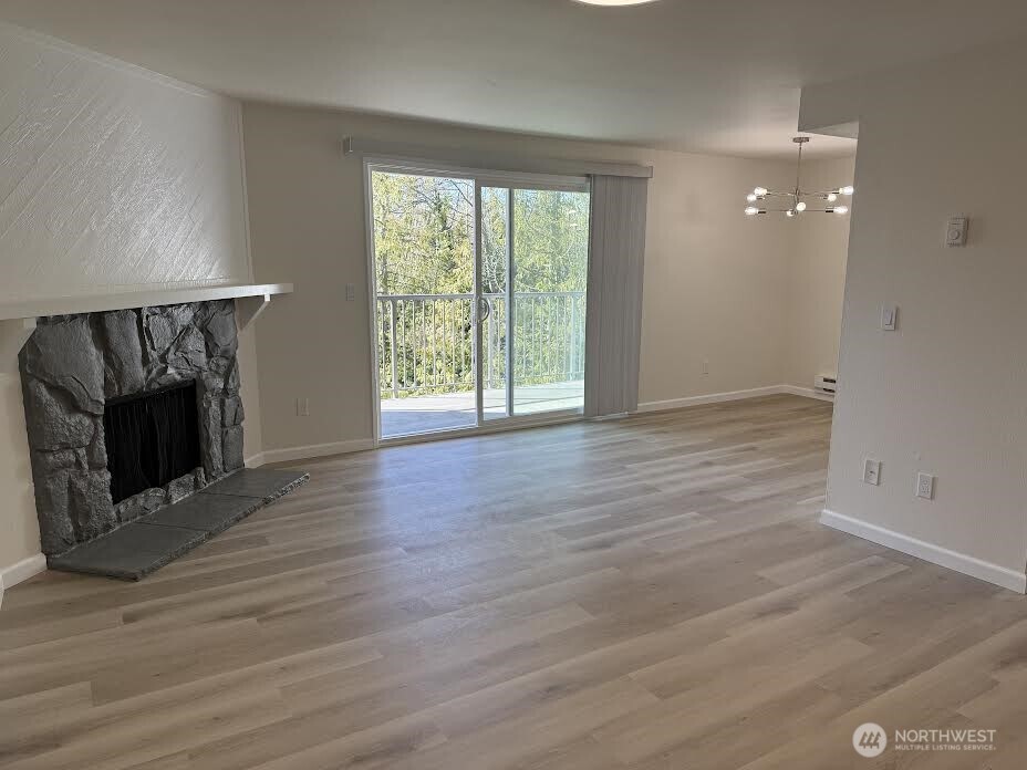 2411 South 248th Street, Unit D24 Kent, WA 98032 - Photo 5 of 21 wooden floor in an empty room with a window