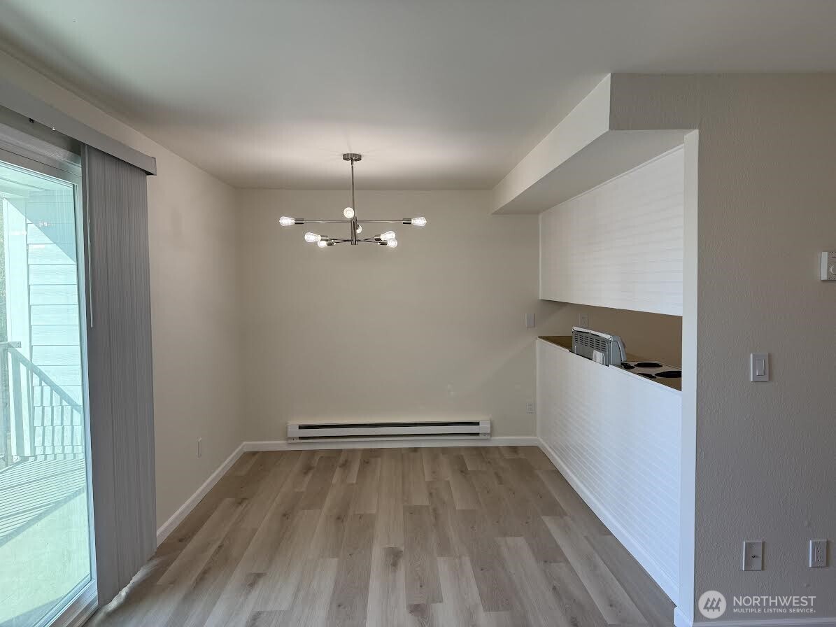 2411 South 248th Street, Unit D24 Kent, WA 98032 - Photo 7 of 21 wooden floor in an empty room with a window