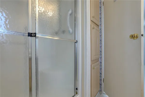 a bathroom with a glass shower door
