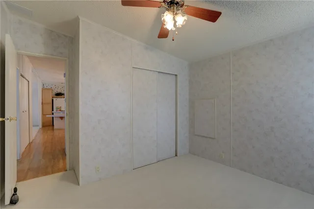 a view of a chandelier fan and entryway