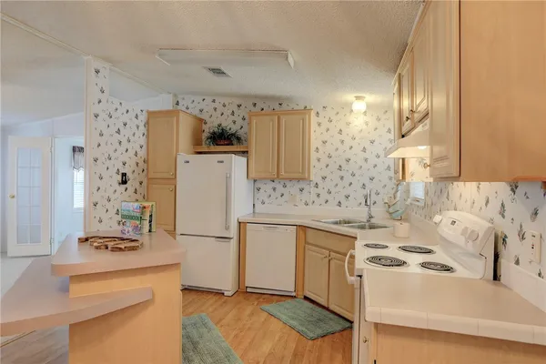 a kitchen with a sink a stove and refrigerator
