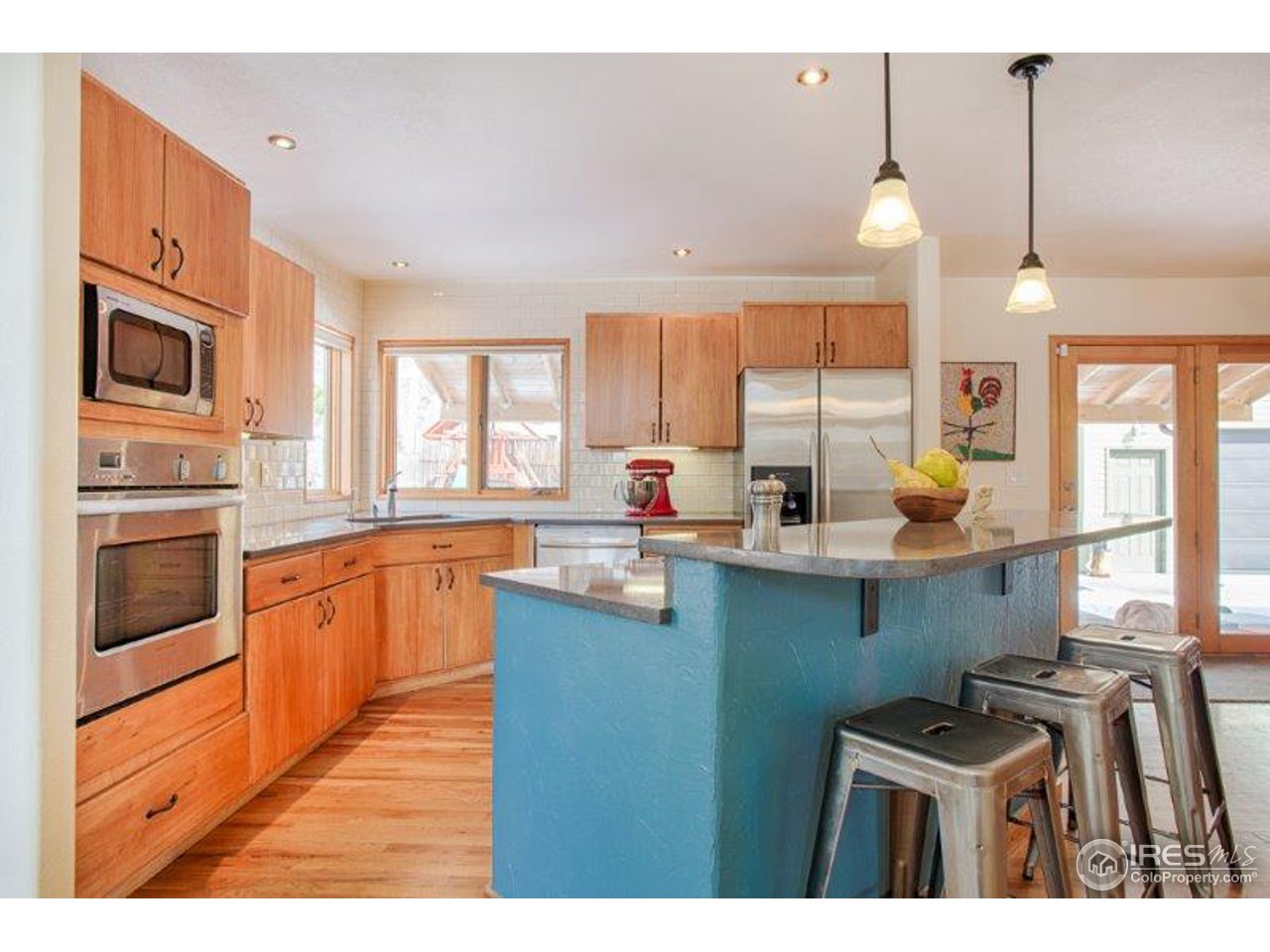 1301 Riverside Avenue Boulder, CO 80304 - Photo 4 of 25 a kitchen with stainless steel appliances kitchen island granite countertop a stove top oven a sink a dining table and chairs