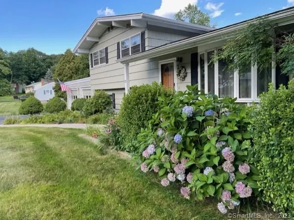 a front view of a house with garden