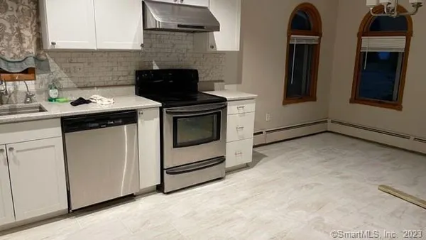 a kitchen with stainless steel appliances a stove microwave and sink