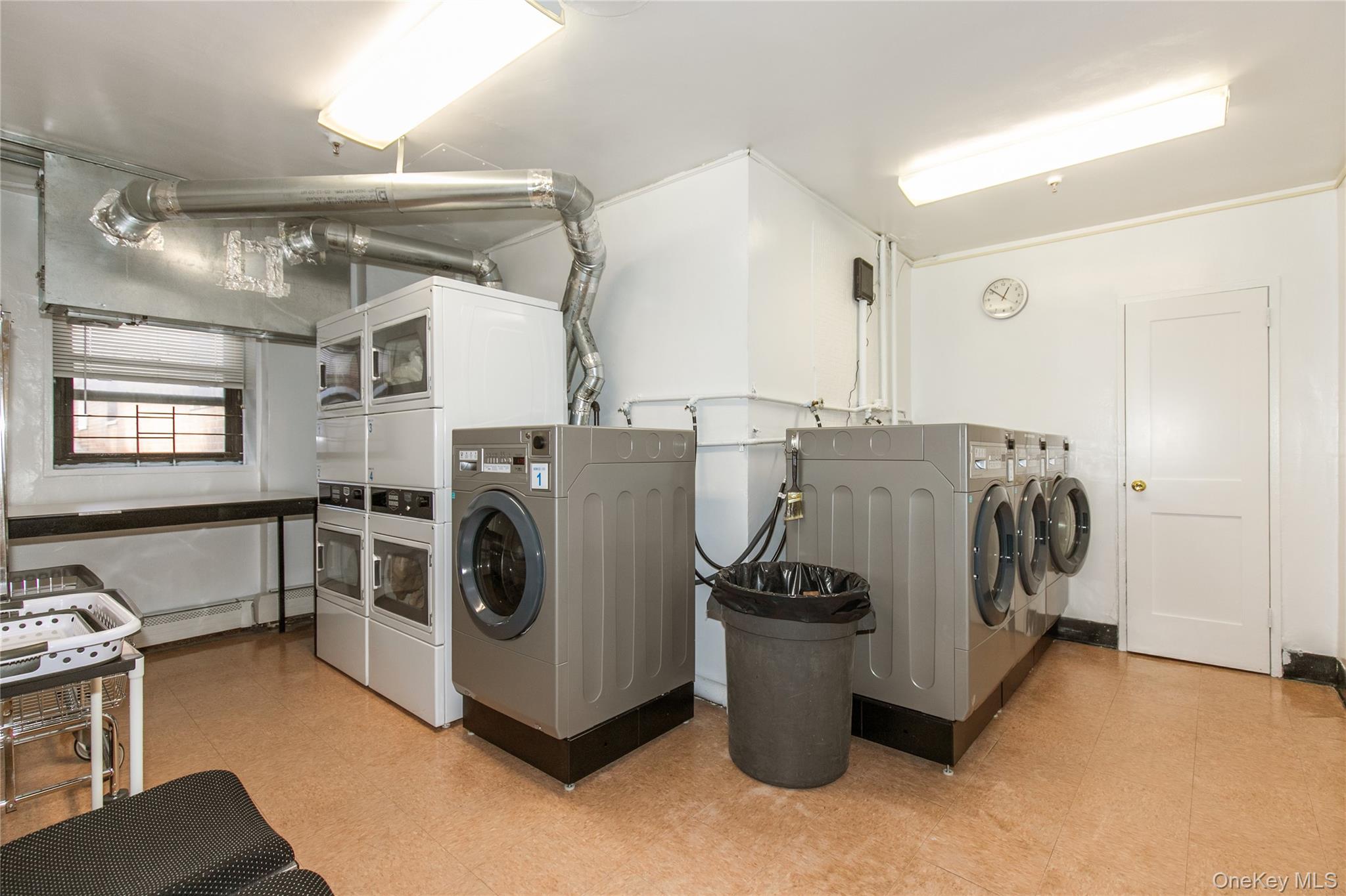25 Park Place, Unit 2G Great Neck, NY 11021 - Photo 15 of 20 a utility room with multiple dryer and washer
