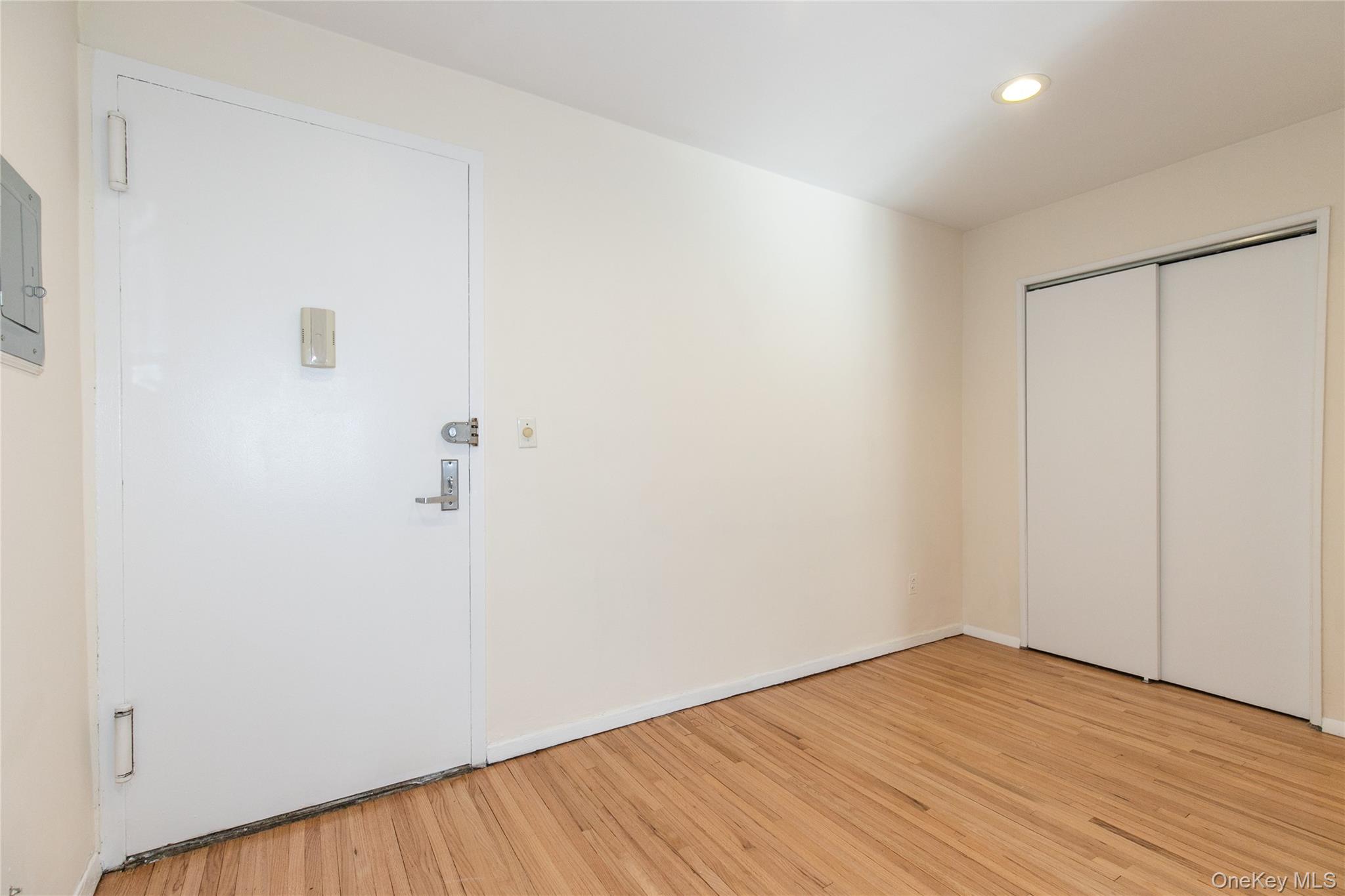 25 Park Place, Unit 2G Great Neck, NY 11021 - Photo 5 of 20 a view of empty room with wooden floor