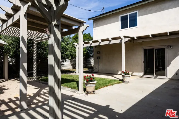 a backyard of a house with fountain and outdoor seating