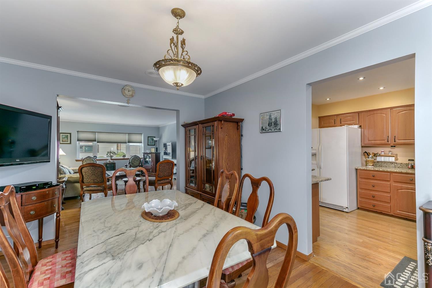7303 Hana Road Edison, NJ 08817 - Photo 12 of 24 a view of a dining room with furniture window and wooden floor