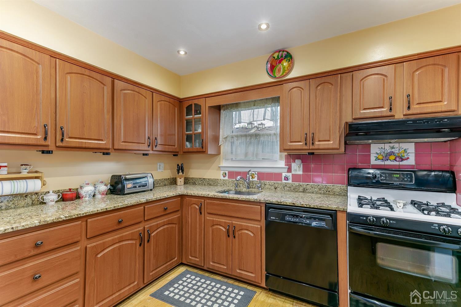7303 Hana Road Edison, NJ 08817 - Photo 14 of 24 a kitchen with stainless steel appliances granite countertop a sink and cabinets