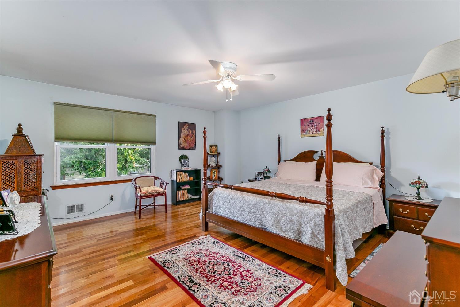 7303 Hana Road Edison, NJ 08817 - Photo 16 of 24 a bed room with a bed and a chair