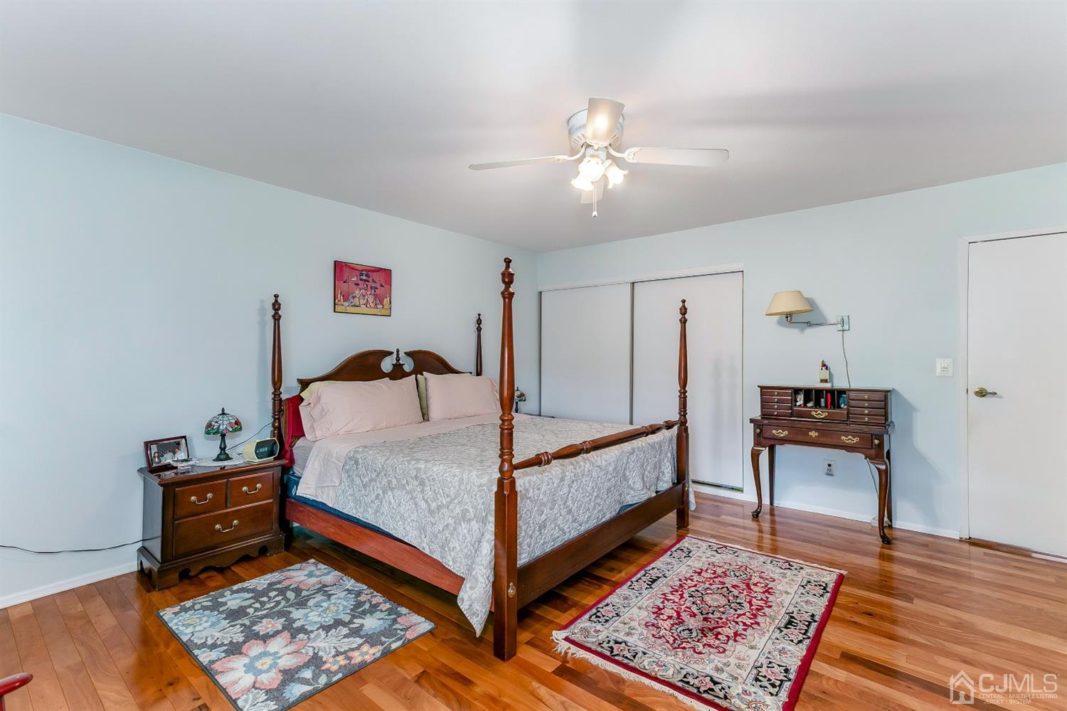 7303 Hana Road Edison, NJ 08817 - Photo 17 of 24 a bed room with a bed and a lamp