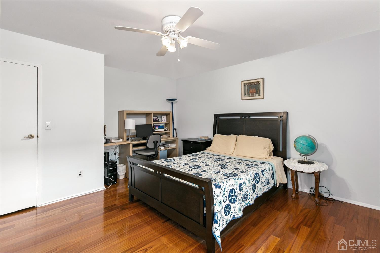 7303 Hana Road Edison, NJ 08817 - Photo 19 of 24 a bedroom with a bed and a chandelier